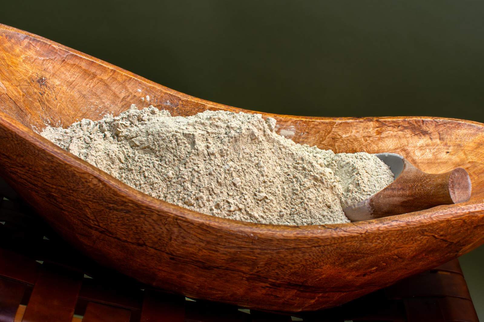 aztec secret clay in wooden bowl with wooden spoon alternative image for slider