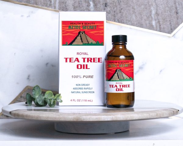 Tea Tree 4 oz bottle with packaging and accent decorations