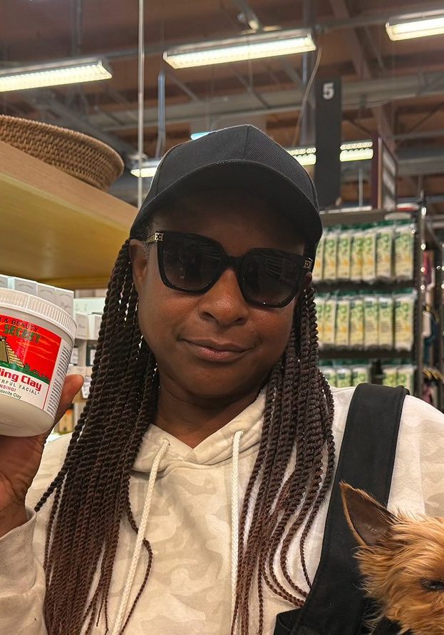 Happy customer with a aztec secret clay mask jar in Venice, CA Whole Foods